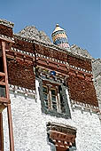 Ladakh - Hemis Gompa, the main monastery halls with the characteristc red painted windows and woden balconies on white washed faades 